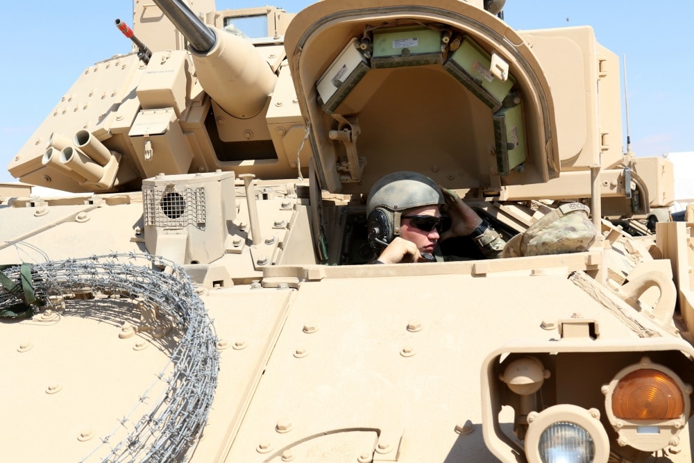 MOHAMED NAGUIB MILITARY BASE, Egypt – Spc. Clifford Crocker, a Bradley Fighting Vehicle driver for the 155th Armored Brigade Combat Team, gets his helmet and microphone adjusted in preparation for the movement to the Situation Training Exercise during Bright Star 18. Crocker and the Soldiers from the 155 would be joined by Jordanian and Egyptian allies to move down the training lane and overcome challenges. (U.S. Army photo by Staff Sgt. Matthew Keeler)