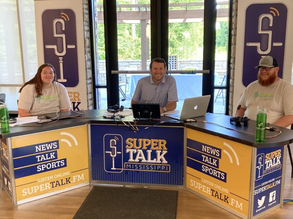 SportsTalk co-host Richard Cross visits with foster parents Chelsea and Taylor Griggs