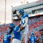 Ole Miss left tackle Diego Pounds lifting quarterback Trinidad Chambliss in the air after a touchdown drive. (Photo from Blake Harrell/SuperTalk Mississippi News)